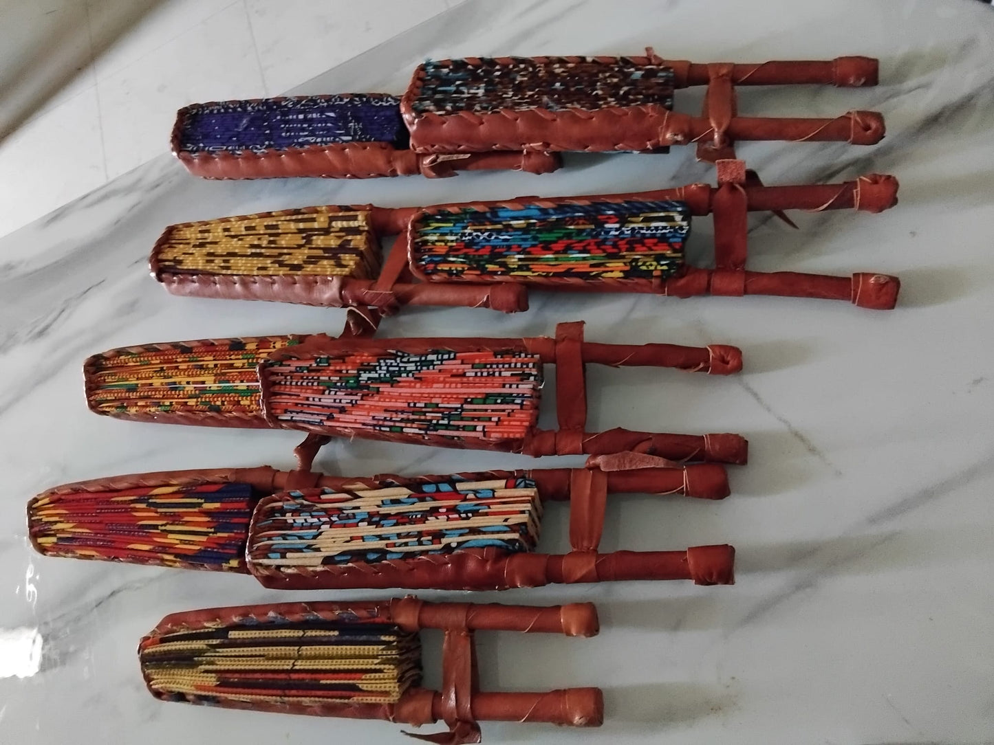 Collection d'éventails artisanaux en wax motifs africains variés · faits main Côte d'Ivoire · Giwax Boutique.